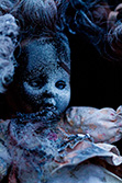 old creepy doll with dress and paint srapy on face
