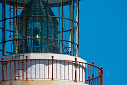 lighthouse top with lantern and gallery, red metal stairs