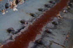 metal beam with rusty bolts