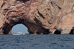 boat in front of Perce rock in Gaspesie in Quebec, pierced rock