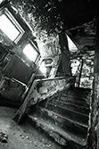 old creepy stairs in abandoned asylum with peeling walls