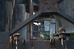 broken windows and steel beams on rusty metal structure
